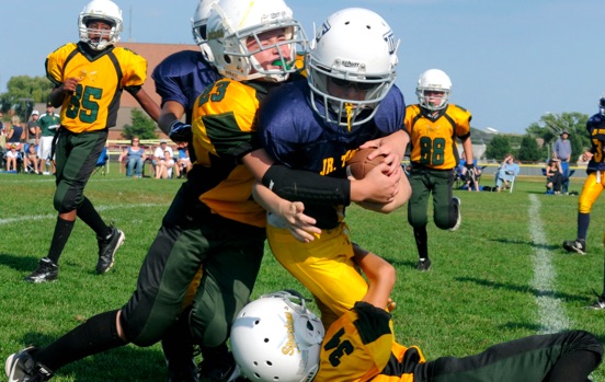 young football player getting tackled