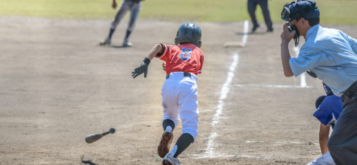 young baseball player running to home plate