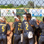 Softball team getting ready to celebrate after a girls softball tournament home run